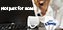 Puppy looking at a turned over cup on a keyboard